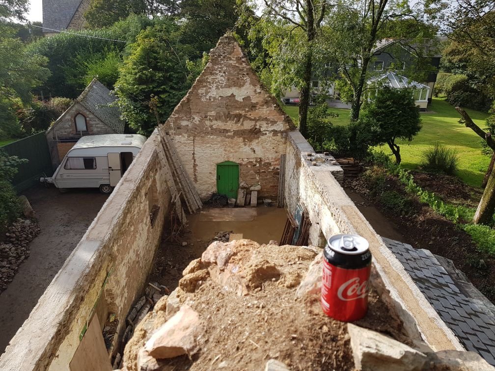 Looking down into the roofless stone shell from the wall top before the rebuild